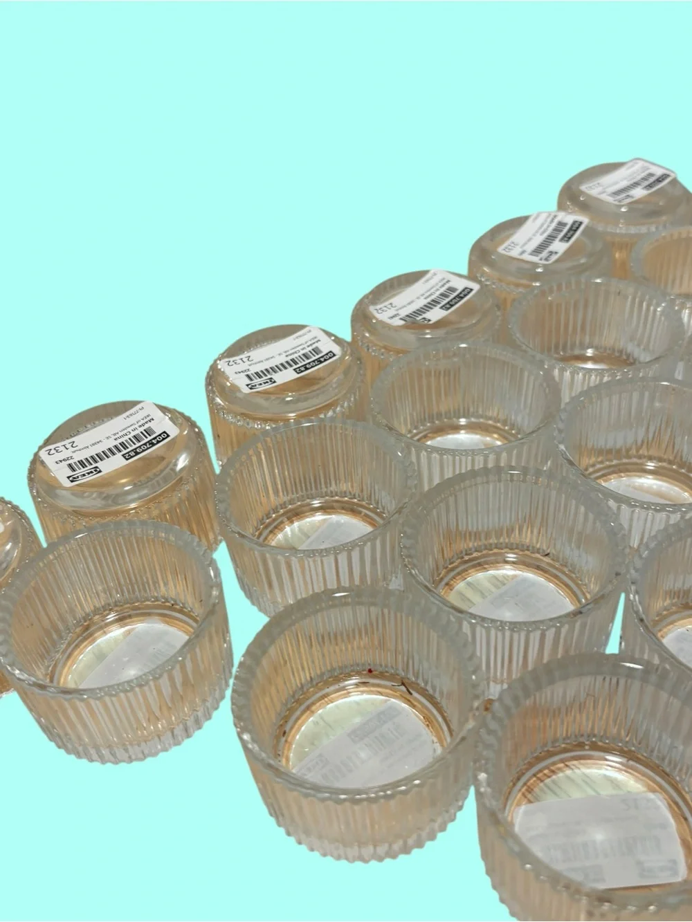 21 IKEA FINSMAK clear glass tealight holders.